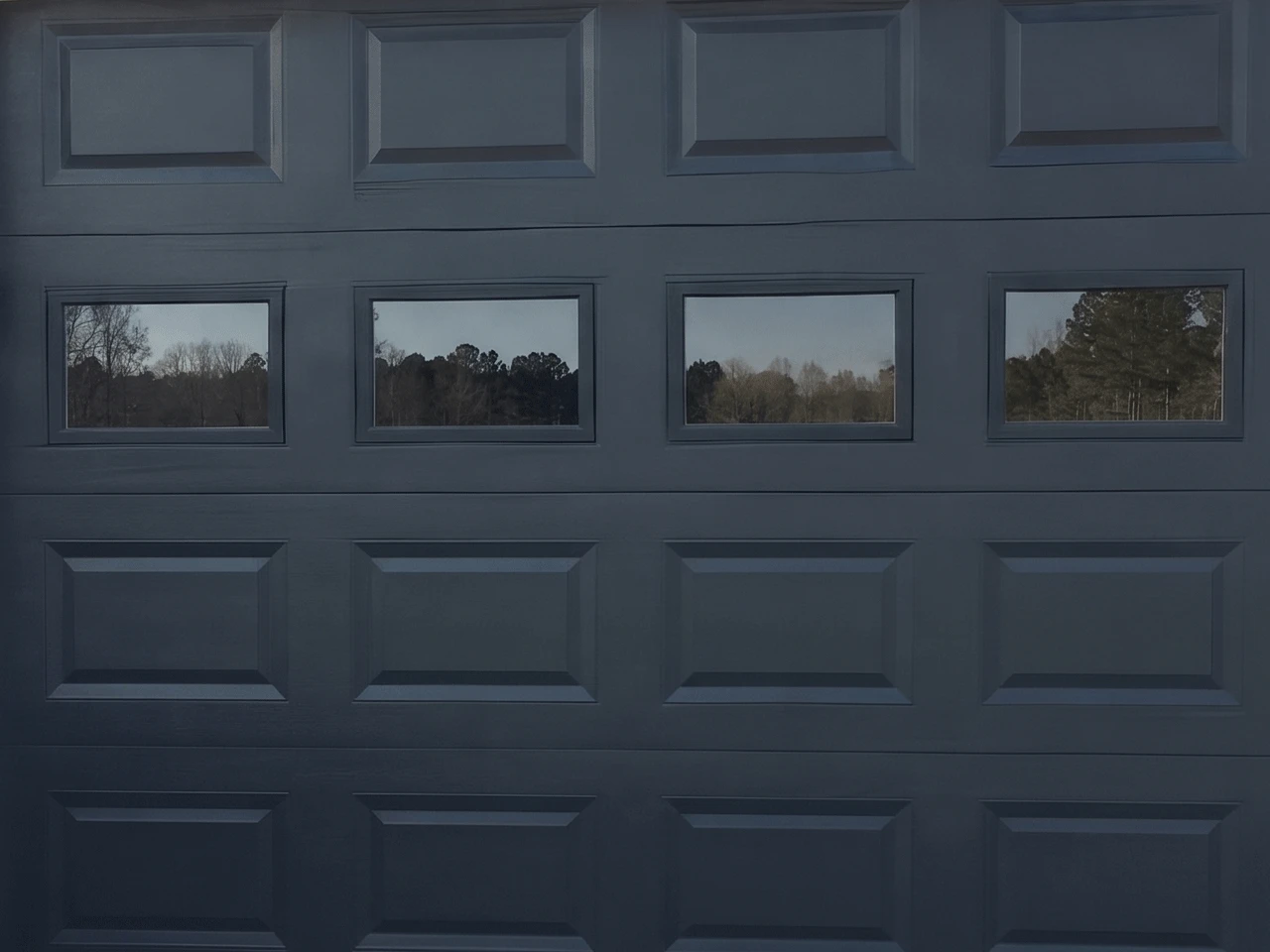 330x510 4-Window Charcoal garage door with four evenly spaced horizontal rectangular windows across the top panel.
